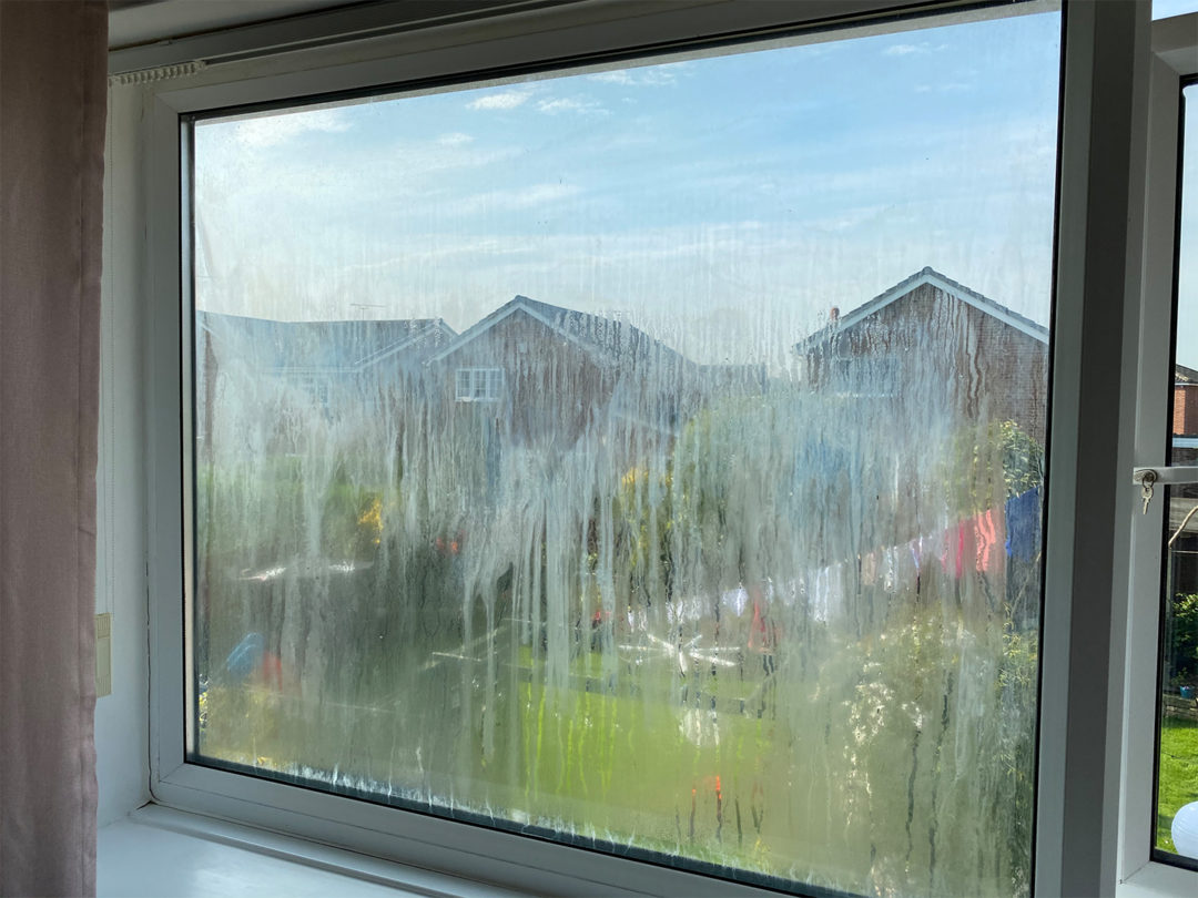 A double glazed window misted up with condensation trapped between the panes